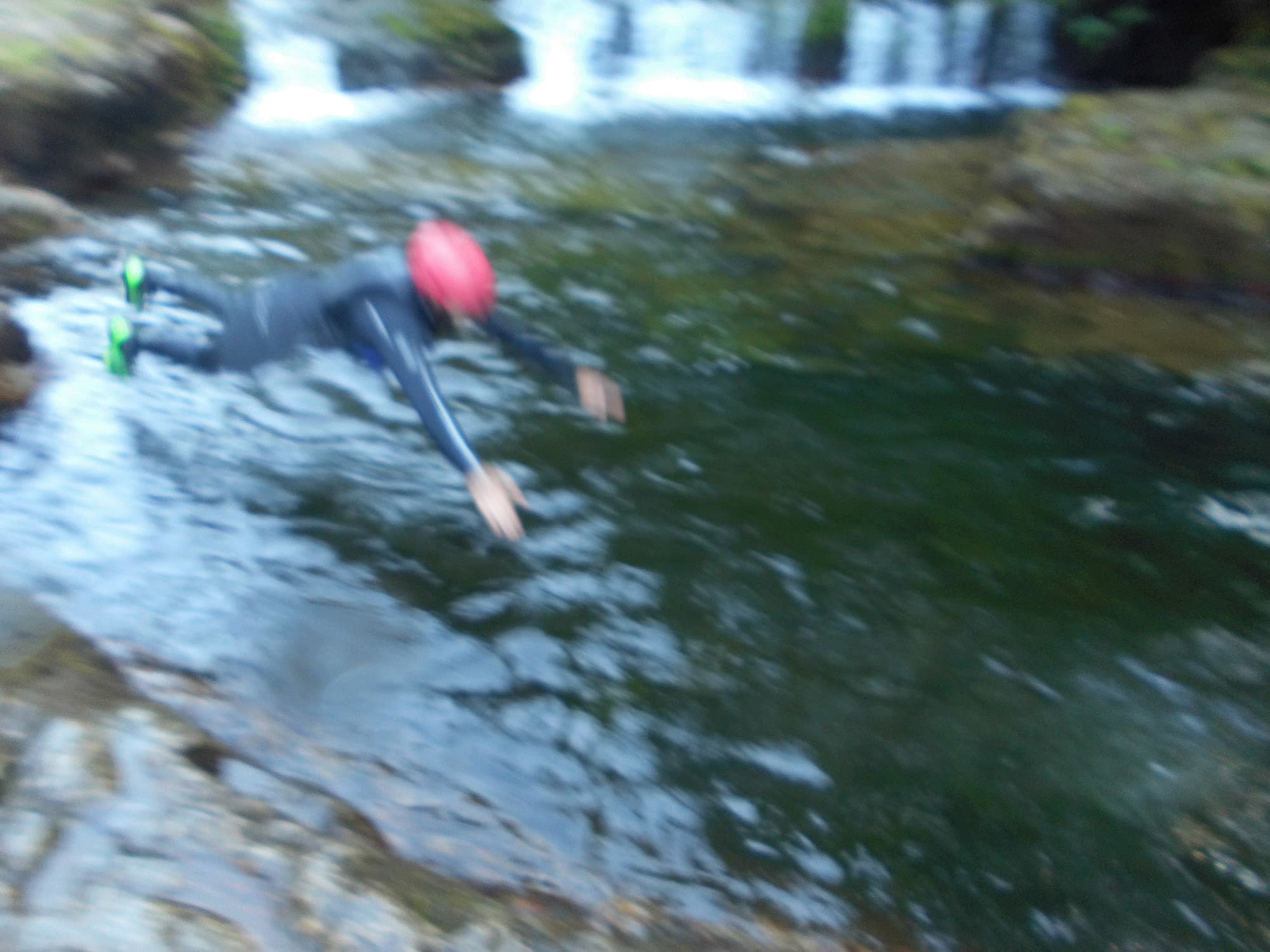 Jumping into the river to start canyoning with wild swimming