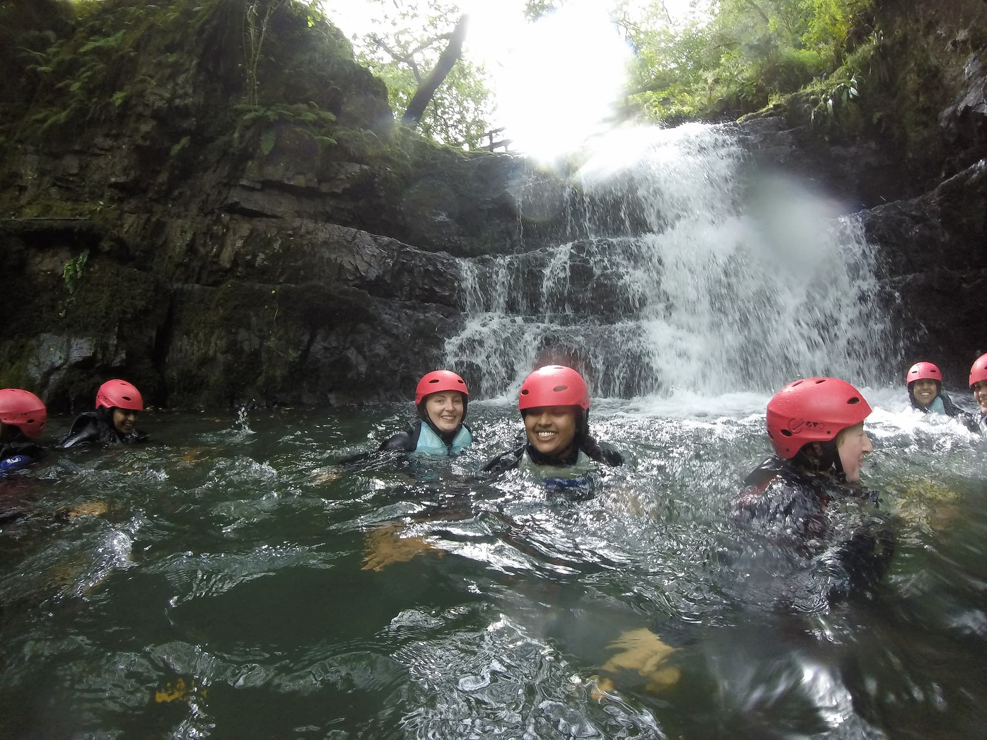 Group in the waterfall pool during gorge walking activity